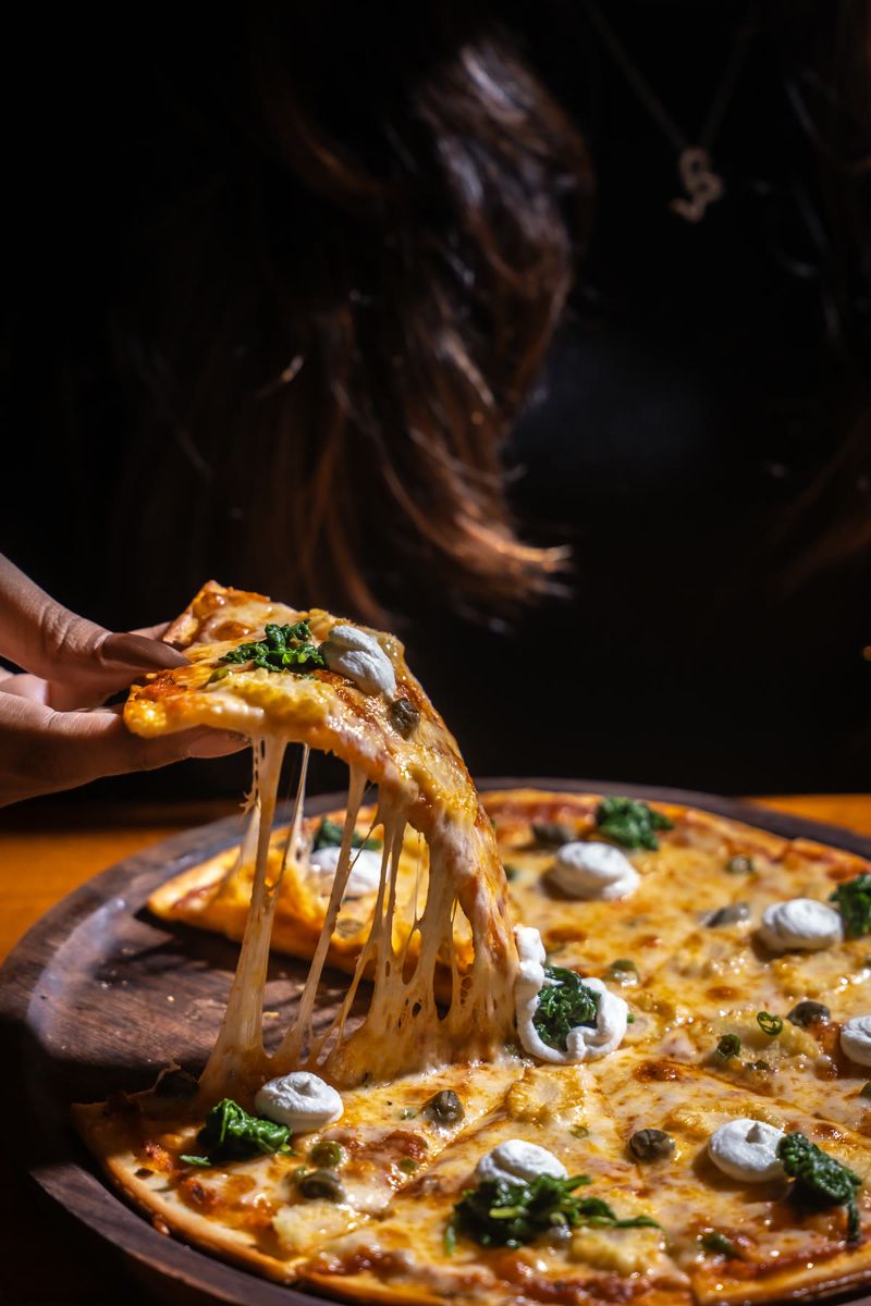 Food photograph by Hiren: a cheese pull from a pizza