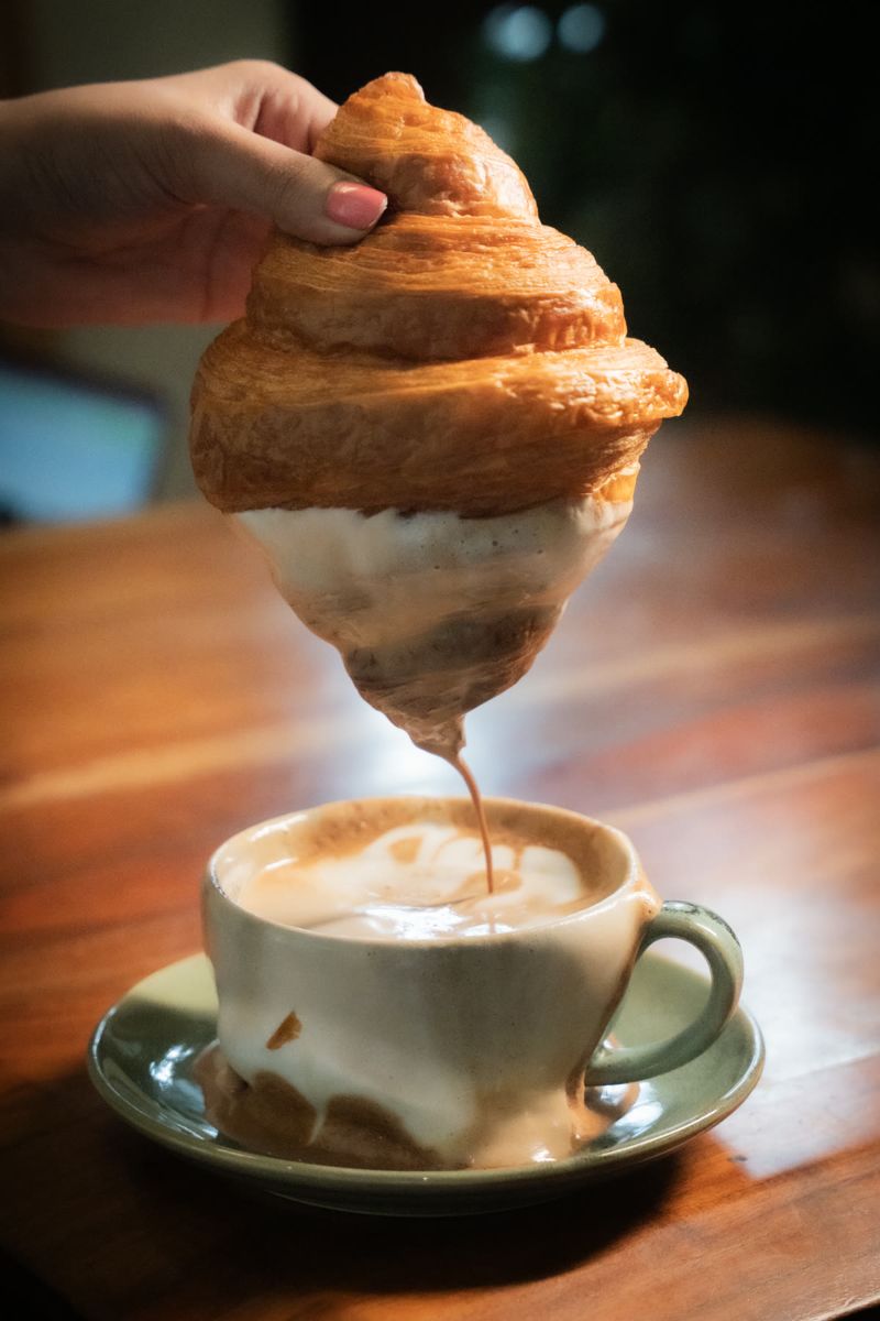 Food photograph by Hiren: a croissant dipped in coffee